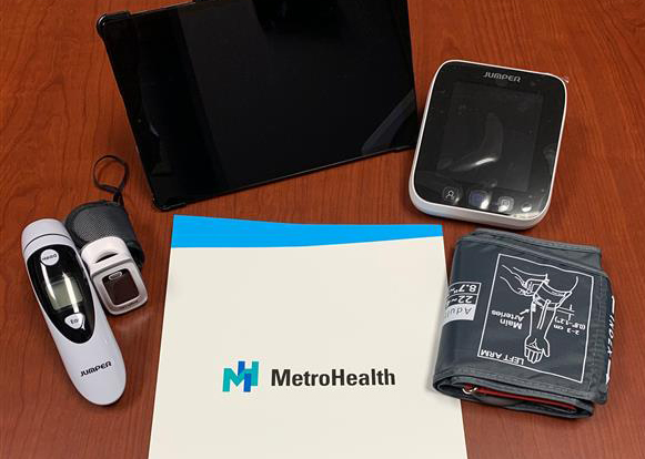 MetroHealth monitors COVID-19 patients in their homes with low-cost devices, including a Bluetooth-enabled tablet, pulse oximeter, thermometer, and spirometer.