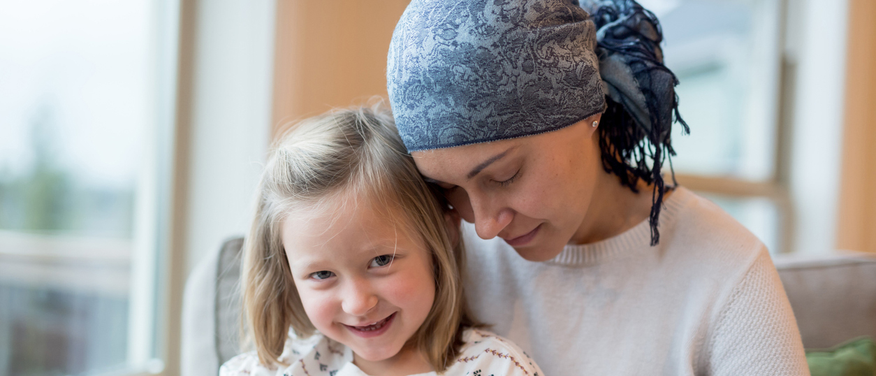 Cancer survivor holds her daughter