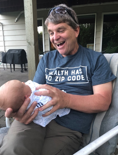 John Cullen, M.D., family physician in Valdez, Alaska with a newborn baby