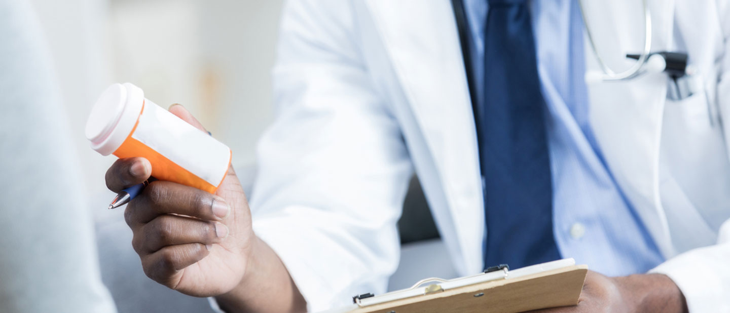 Doctor giving out drugs to patient