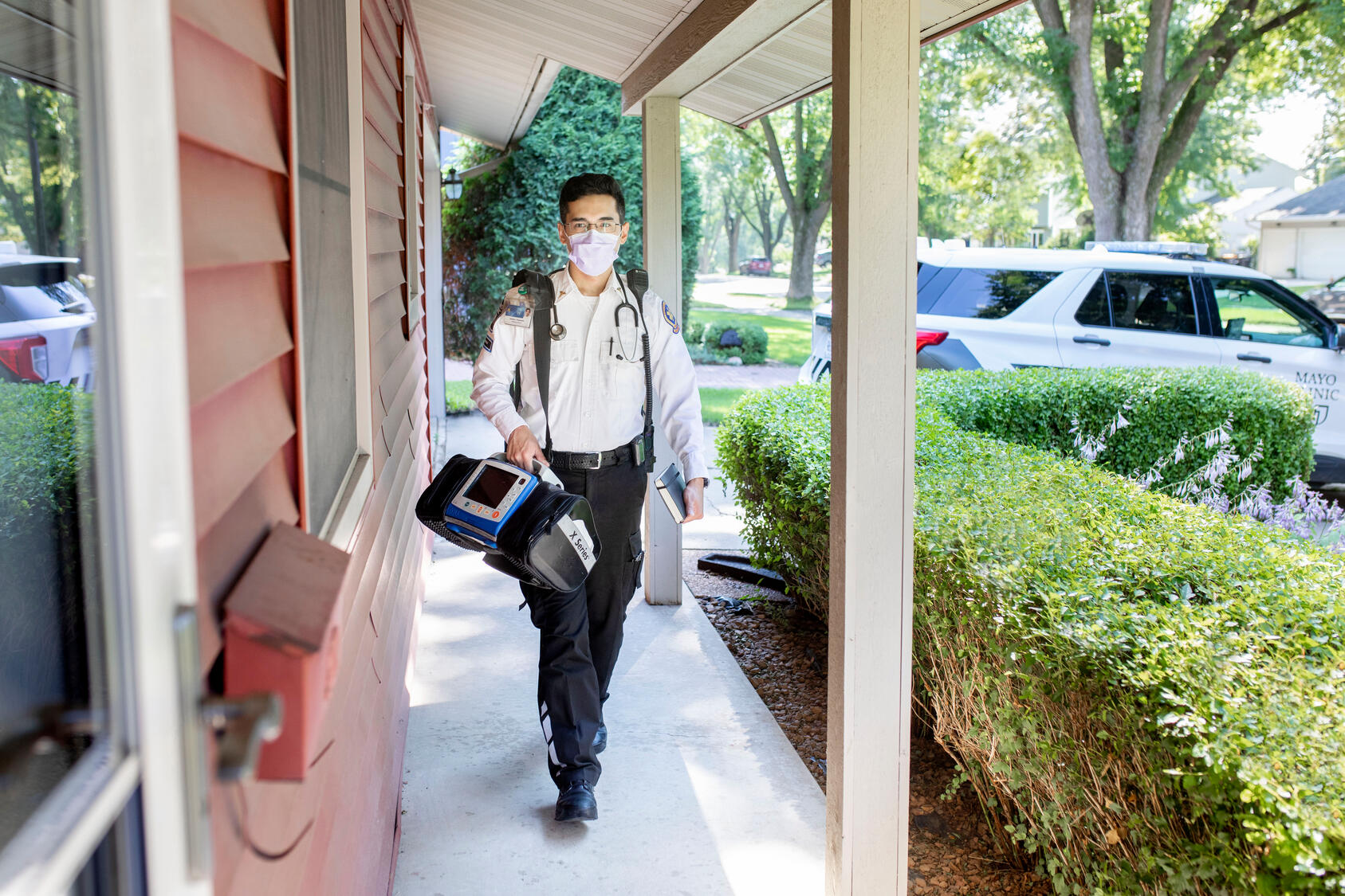 A mayo Clinic paramedic visits a patient at home.