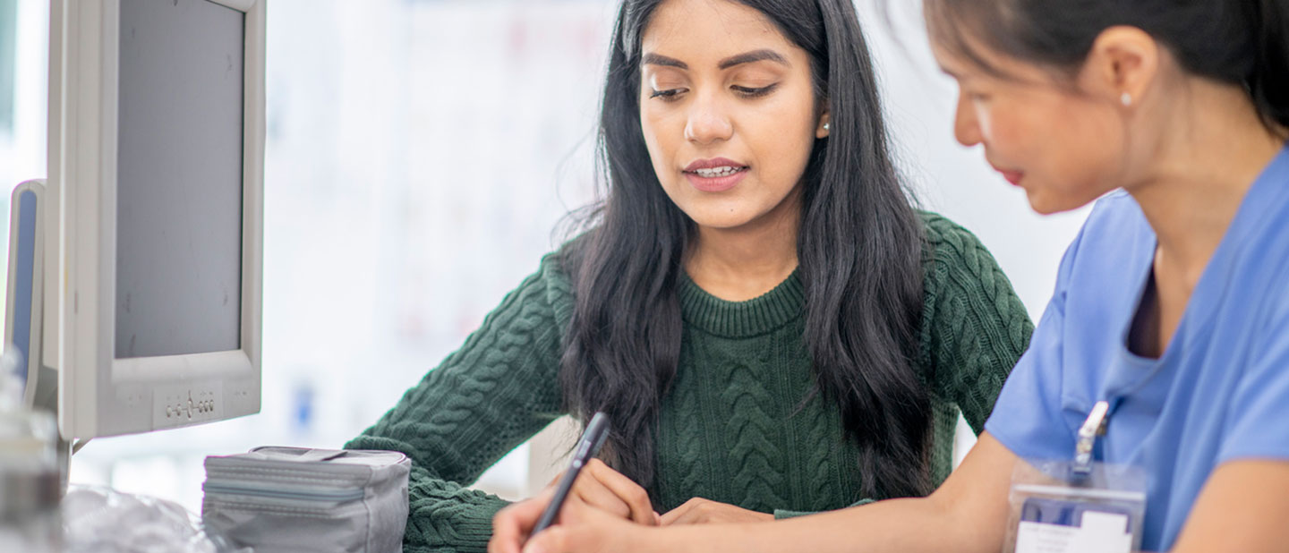 female with health insurance visiting doctor