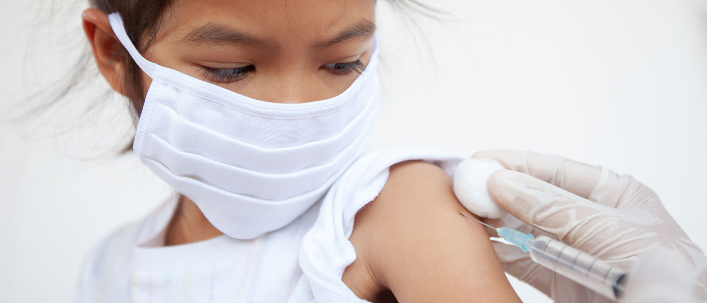 masked girl gets immunization