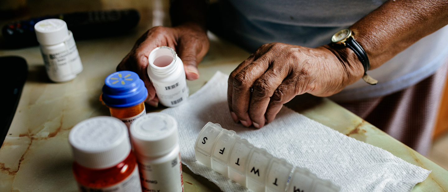 patient laying out prescription drugs for the week