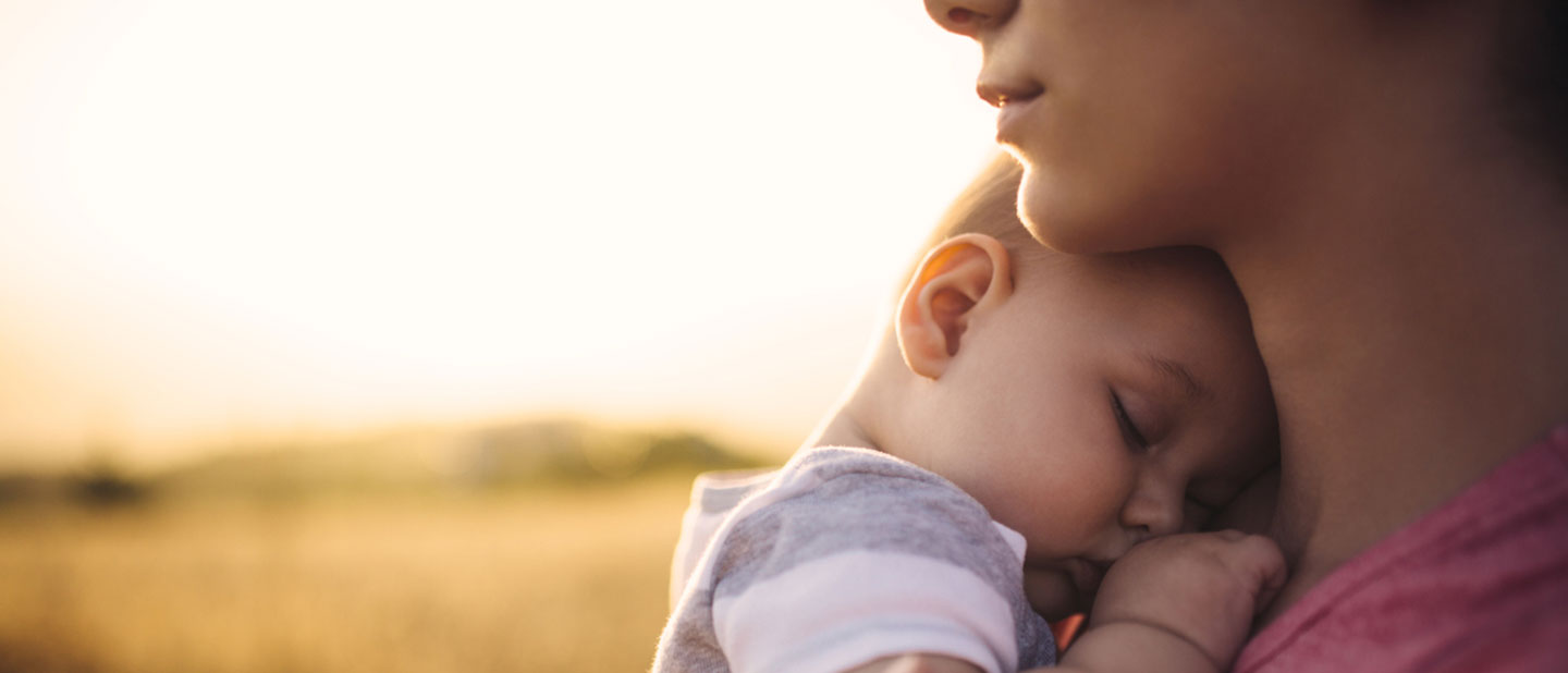rural woman with new infant in field