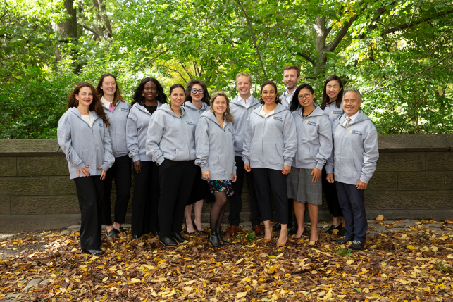 Group of Harkness fellows in park in sweatshirts