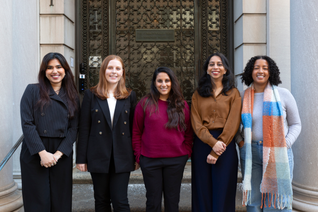Five women posing for a photo standing in front of the Commonwealth Fund building