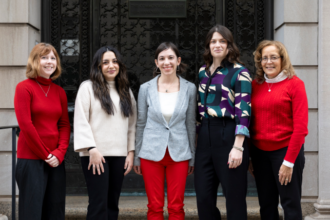 Five women posing for a photo standing in front of the Commonwealth Fund building