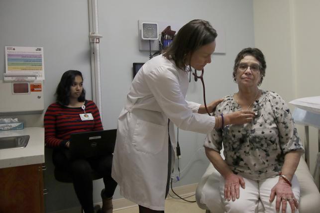 doctor examines patient in doctors office