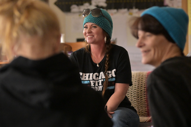 Female paroles sitting and smiling in a group wellness and therapy class