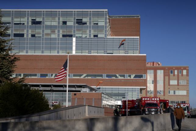 hospital exterior with flag and ambulances