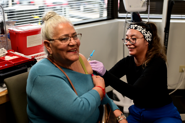Nurse gives woman an injection