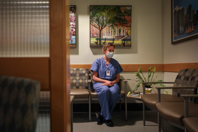 Nurse sits in hospital lounge.