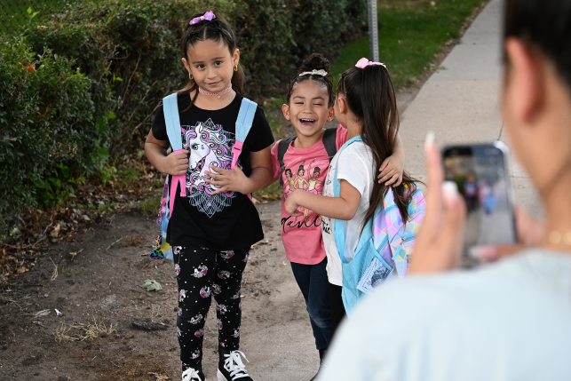 Photo, kids in backpacks laughing together