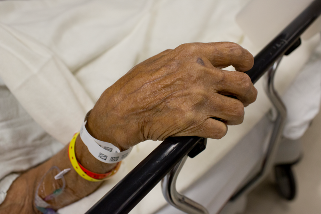 An elderly patient admitted to the emergency room waits to be seen by a doctor.