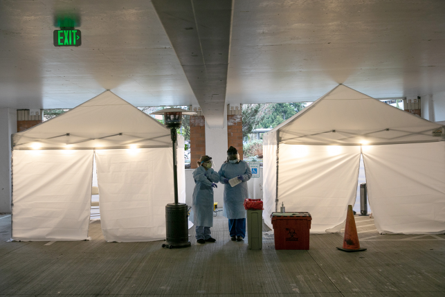 Nurses check registration lists before testing patients for coronavirus at the University of Washington Medical center