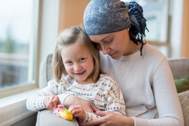 Cancer survivor holds her daughter