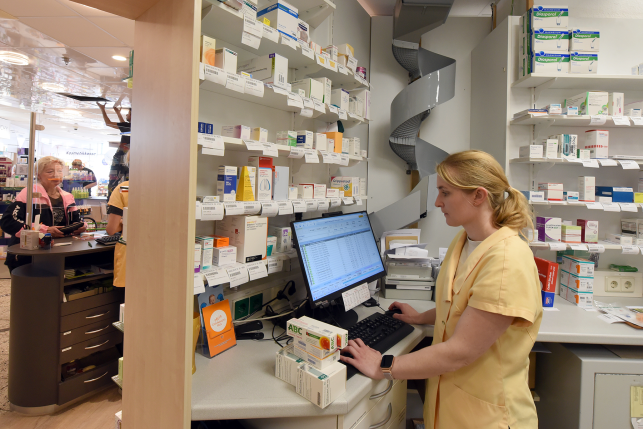 Pharmacy worker at computer