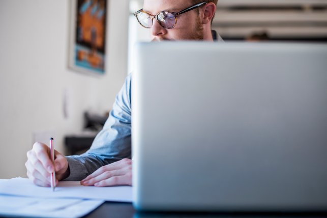 man on computer doing paperwork