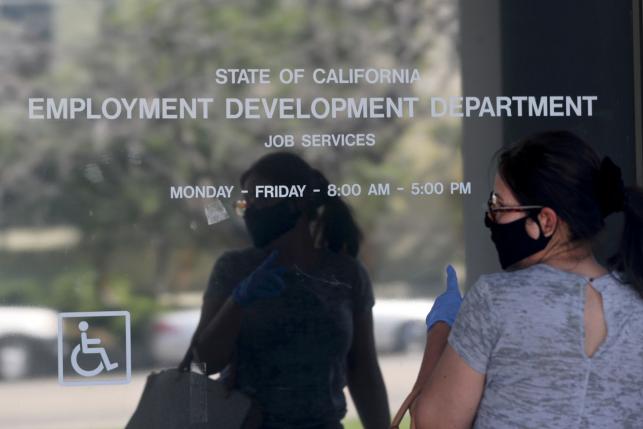 Woman outside an unemployment office during the COVID-19 pandemic