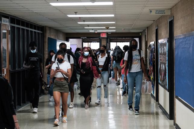 Teens walking in the hallway of Eleanor Roosevelt High School