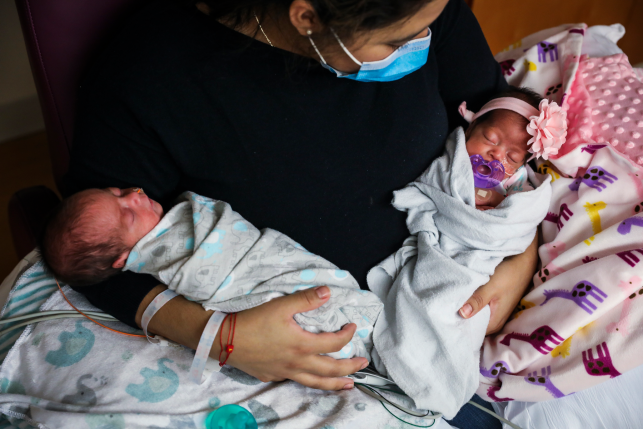 Lisseth Hernandez holds her twins in the neonatal intensive care unit at Tufts Medical Center in Boston on May 13, 2020. As Medicaid eligibility redeterminations resume after a three-year hiatus because of the COVID-19 pandemic, continuity of care will be critical for people who are in the midst of treatment, pregnant, or have serious chronic conditions. Photo: Erin Clark/Boston Globe via Getty Images