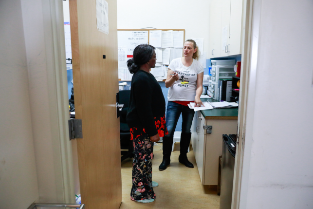 Two women talk in clinic room