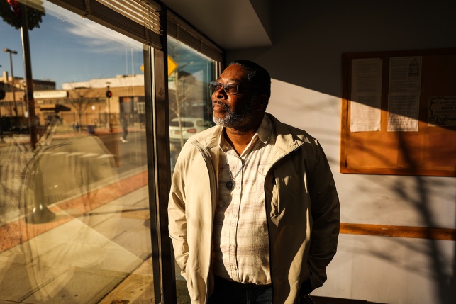 Photo, man stares out window