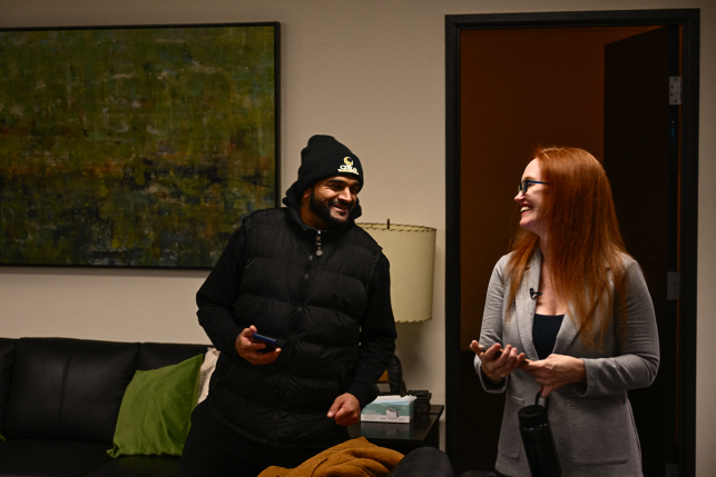 Woman and man talk together with phones in hands