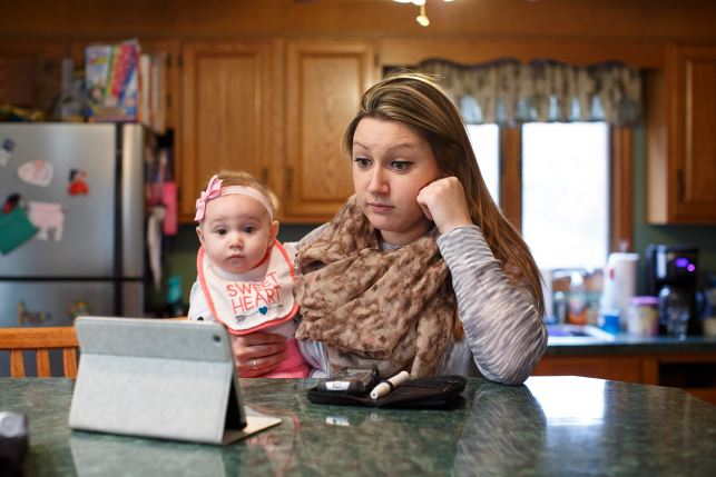 Woman and baby look at ipad
