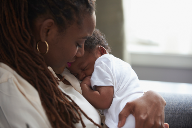 Mother cradling newborn baby