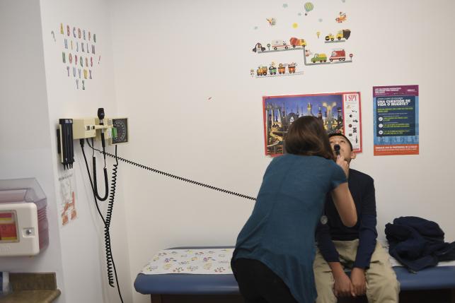 A pediatric doctor performs an exam 