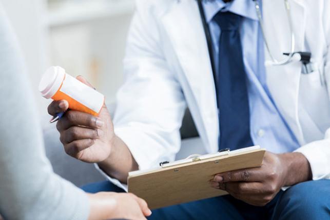 Doctor giving out drugs to patient