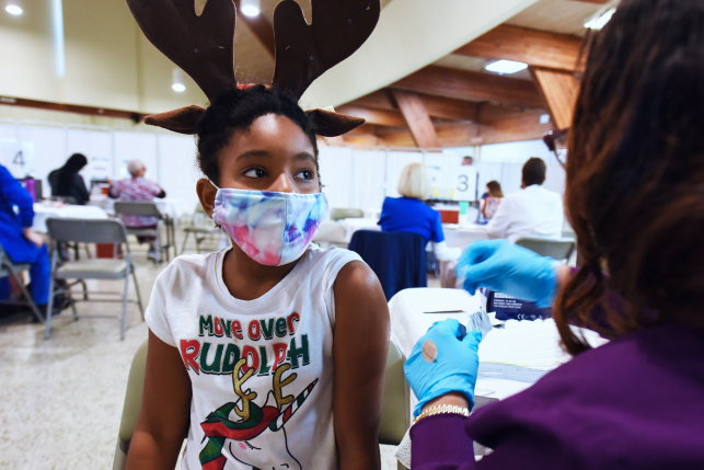 A health worker prepares to administer a dose of Pfizer covid-19 vaccine to a girl at the Sanford Civic Center.