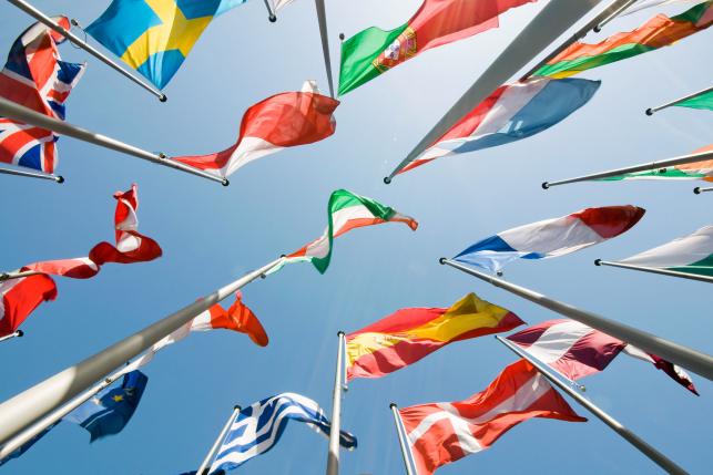 A view from underneath a group of different flags from around the world