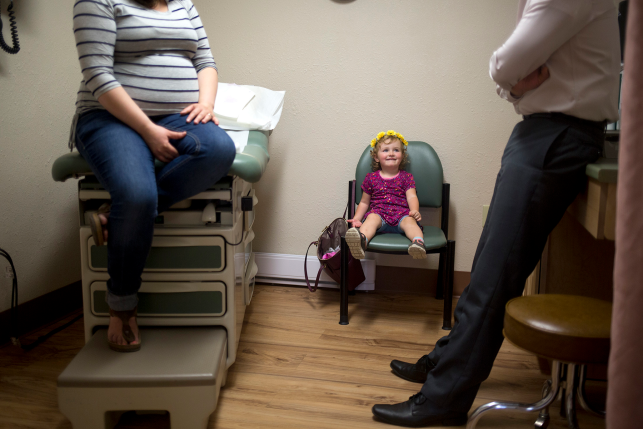 Pregnant mother and daughter at doctors office