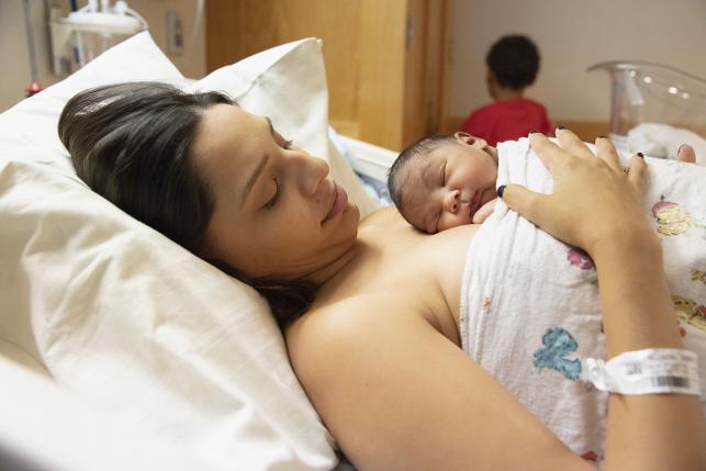 Woman holding newborn baby in the hospital