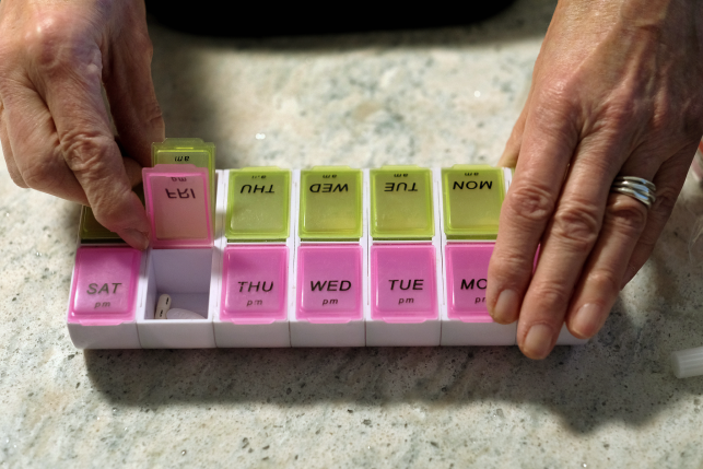  Maureen Dixon displays her pills organizer that she uses to keep track of the prescription drugs, vitamins, insulin and arthritis injections she takes at her home in Medford, MA on Jan. 9, 2020. 