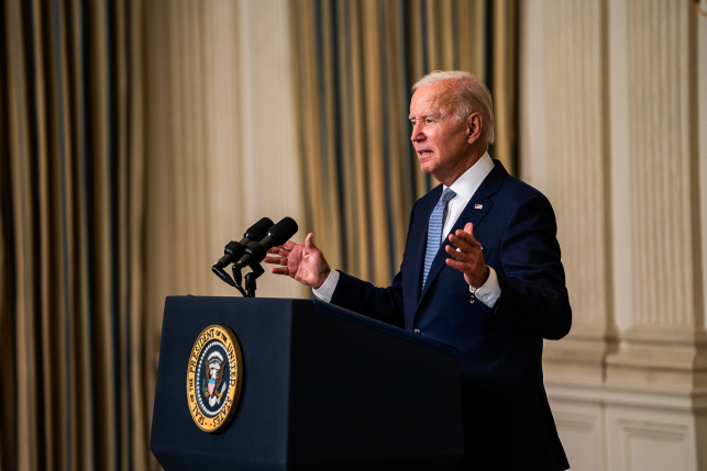 President Joe Biden stands at podium