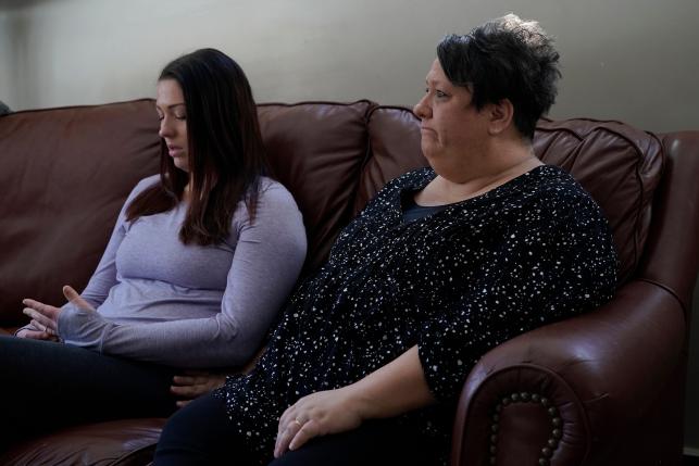 Mother and daughter sitting on a couch