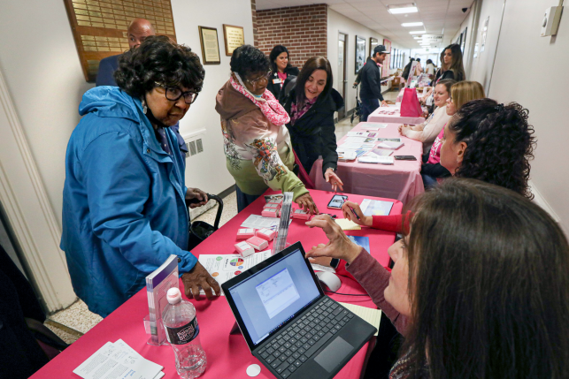 Gina Flores helps Theresa Bedford sign up for a free mammogram during a health fair at Babylon Town Hall in Lindenhurst, N.Y., on Oct. 4, 2022. The Affordable Care Act’s preventive care, no cost-sharing provision is in jeopardy after parts of it were invalidated by a Texas federal court judge. Photo: John Paraskevas/Newsday RM via Getty Images