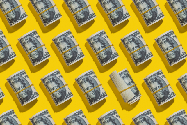 rolls of twenties on a yellow background