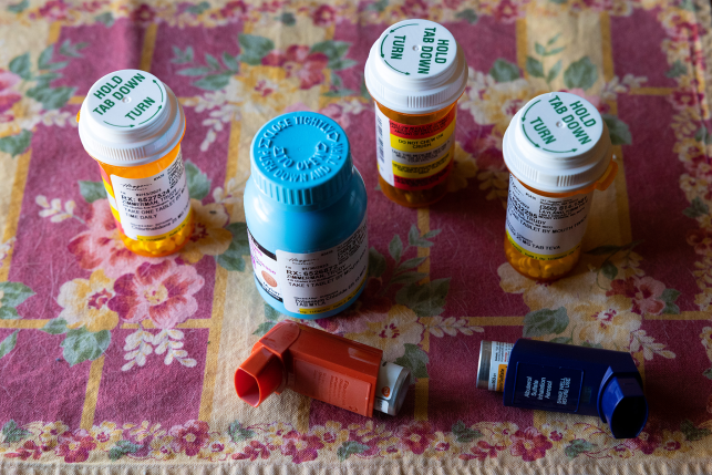 Pill bottles on tablecloth with inhalers
