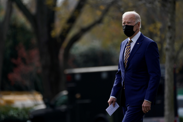 President Biden in a mask walks on the South Lawn of the White House