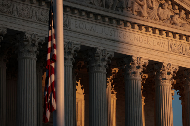 Shadowy image of the American flag in front of the Supreme Court building