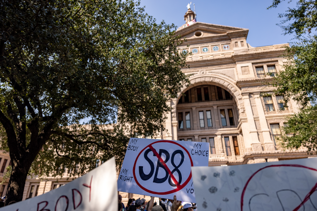 Signs against SB8 raised in front of courthouse building