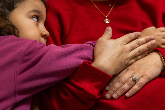Child rests on moms belly