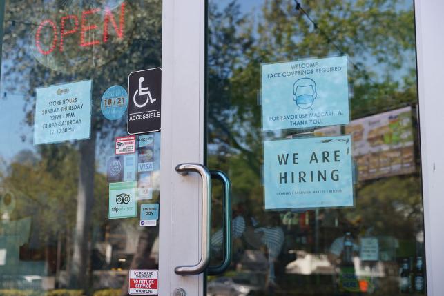 A "we are hiring" sign in front of a store in Miami, Florida, on March 5, 2021.