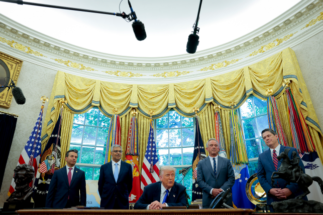 Trump and advisors behind desk in White House