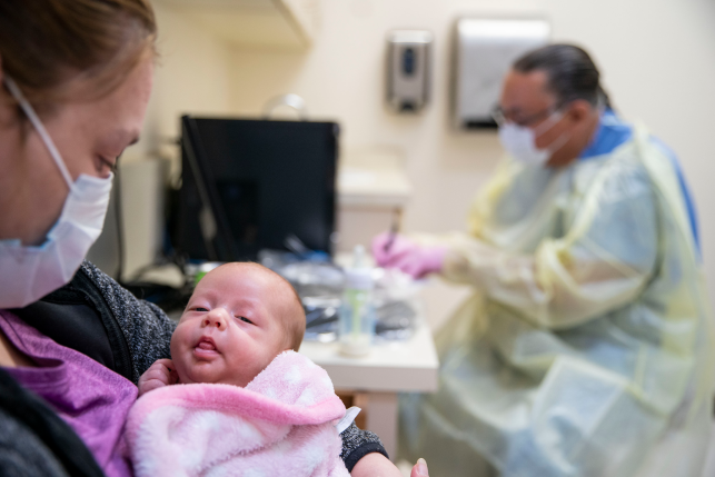 Cerri McKeon holds her two-month-old daughter at the Min No Aya Win clinic on the Fond du Lac reservation in Cloquet, Minn., on May 6, 2020. 